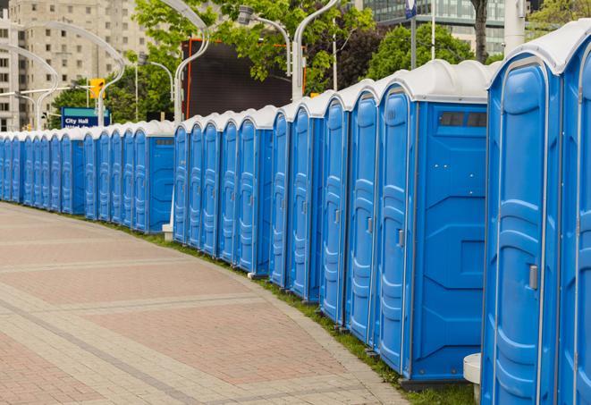 a row of portable restrooms set up for a large athletic event, allowing participants and spectators to easily take care of their needs in Aberdeen NJ